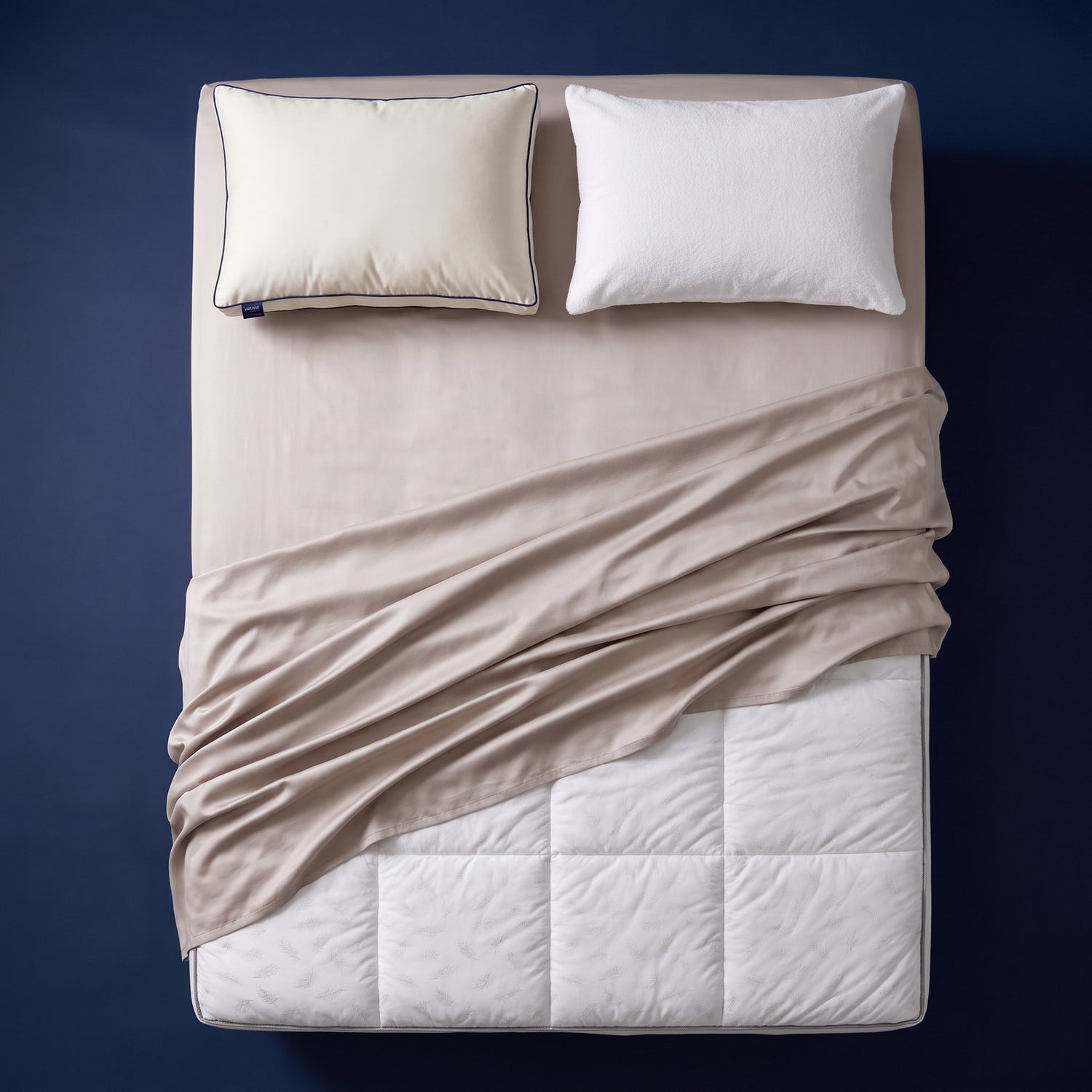 The Complete Sleep System - bamboo sateen sheet set, quilted mattress topper, support pillow and pillow protector arranged on a made bed, viewed from above