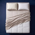 The Complete Sleep System - bamboo sateen sheet set, quilted mattress topper, support pillow and pillow protector arranged on a made bed, viewed from above