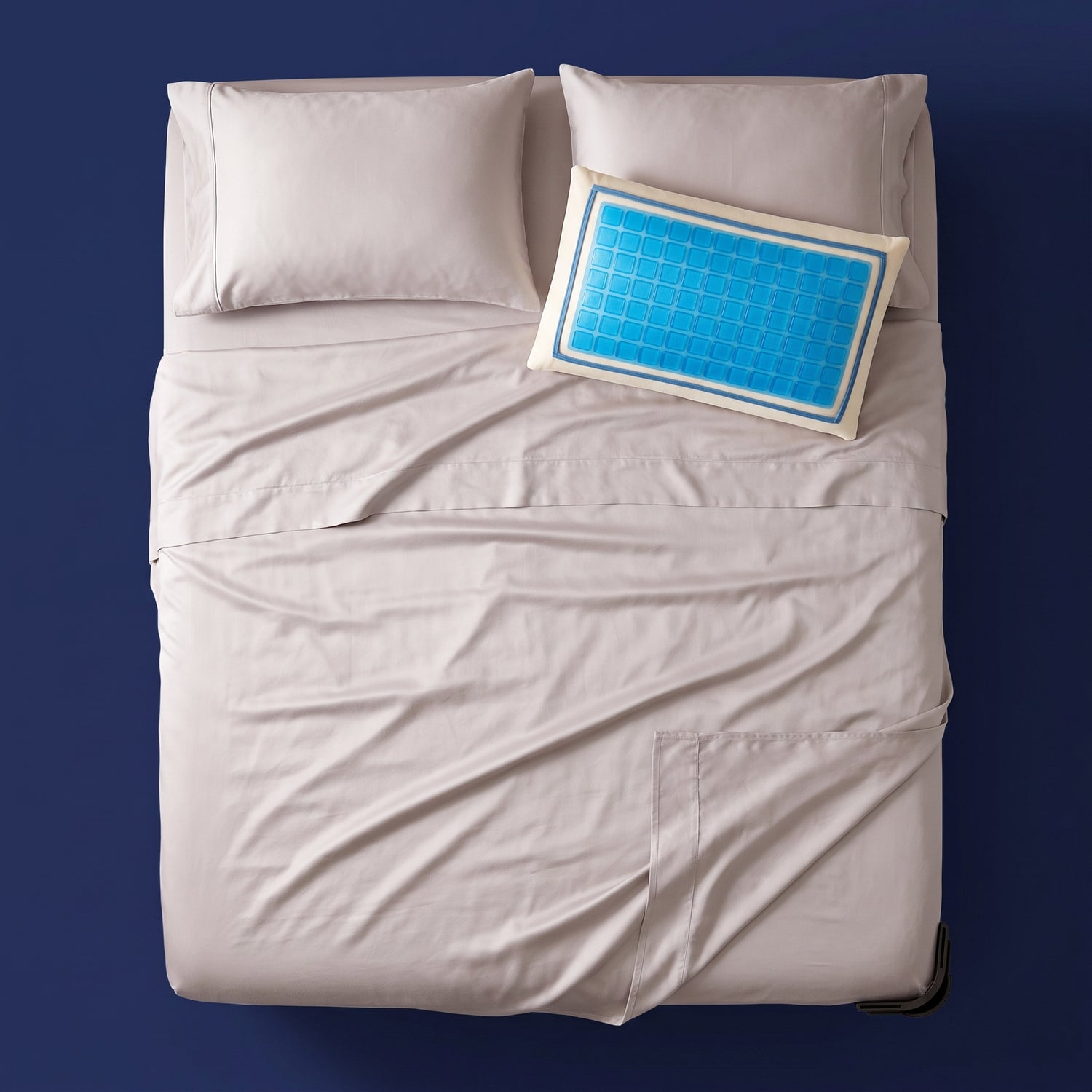 The Cool-All-Night Set - bamboo sateen sheet set with cooling gel pillow and a corner sheet clip on a made bed, viewed from above