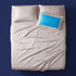 The Cool-All-Night Set - bamboo sateen sheet set with cooling gel pillow and a corner sheet clip on a made bed, viewed from above