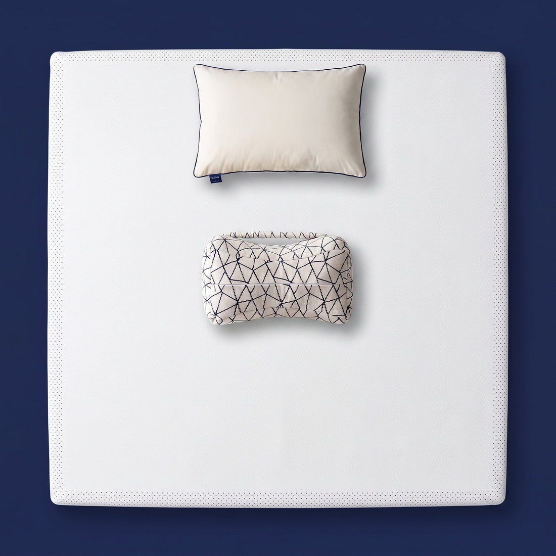 The Orthopedic Recovery Set - memory foam mattress topper, support pillow and knee pillow arranged on a made bed, viewed from above