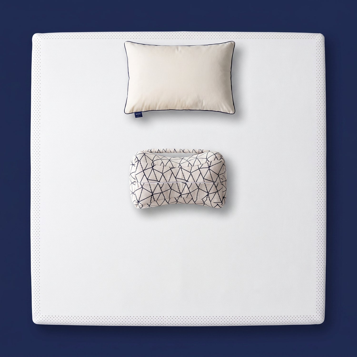 The Orthopedic Recovery Set - memory foam mattress topper, support pillow and knee pillow arranged on a made bed, viewed from above